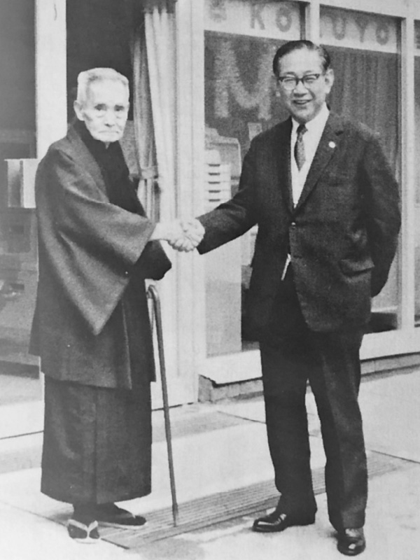 1950年（昭和25年）コクヨ社長と握手する勝明初代社長